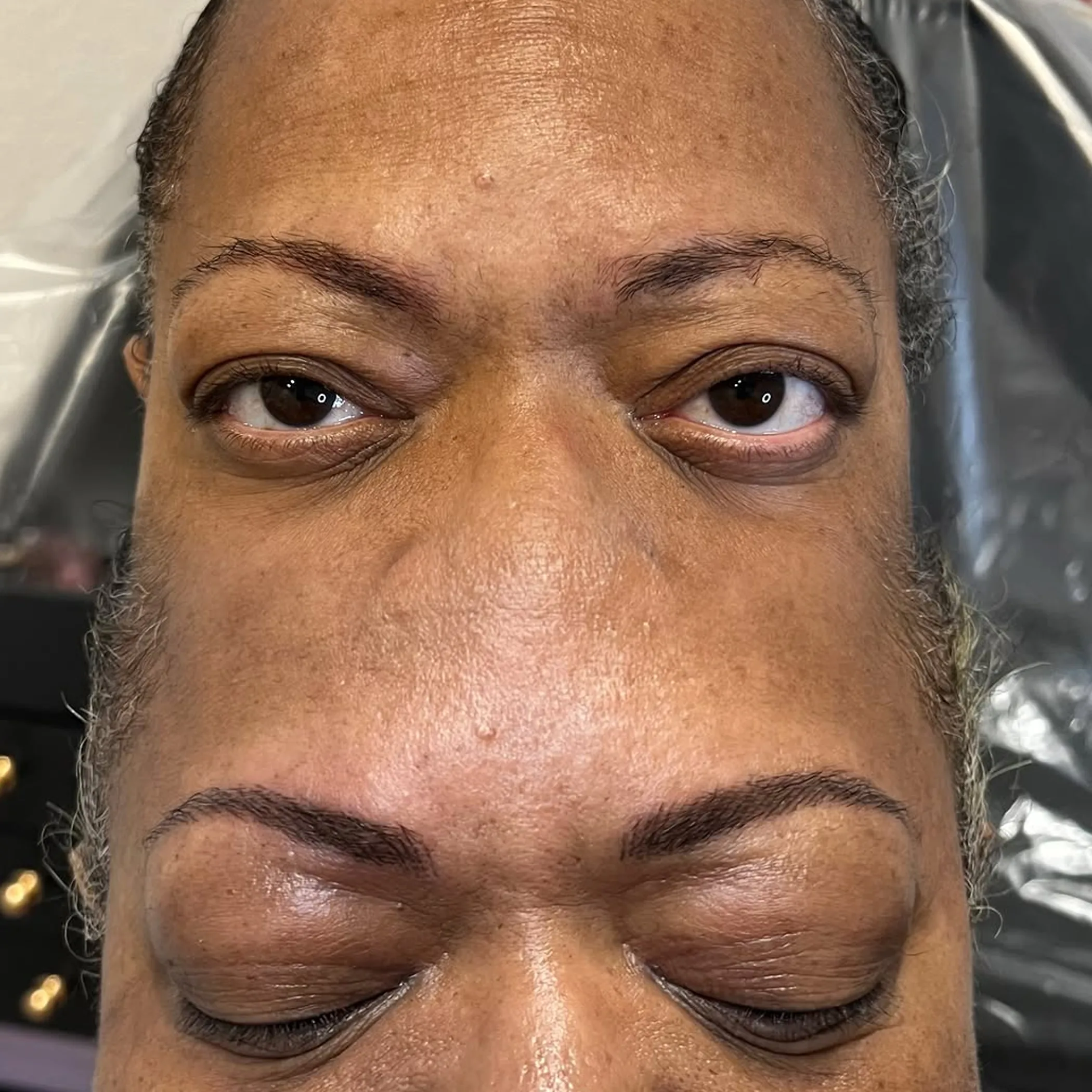 microblading procedure applying fine eyebrow strokes